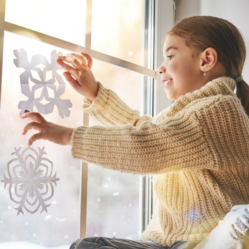 Child making paper snowflakes