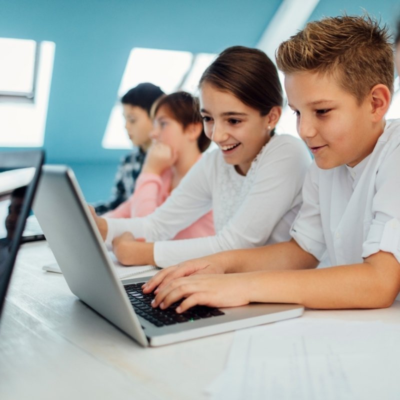 School children using laptop