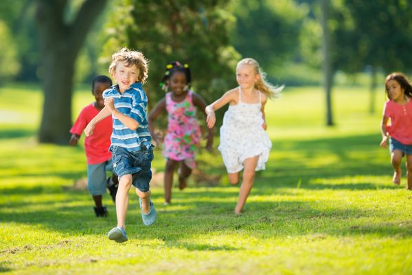 group of children running in park